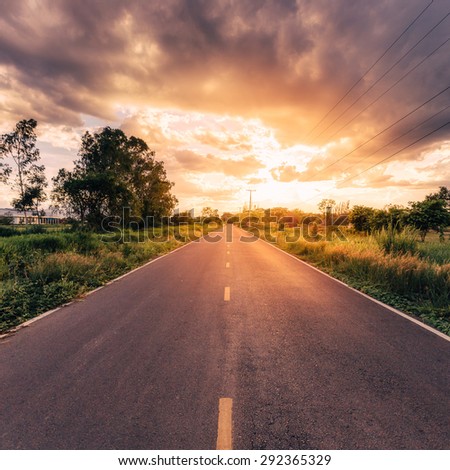 country road and field with beautiful sunset vintage