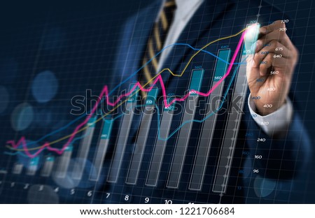 Business growth, progress or success concept. Businessman is drawing a growing 3d virtual hologram graph on dark tone background.