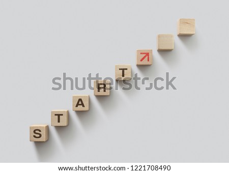Wooden blocks arranged in stair shape with the word START. Start, Start up, new career or new business, start to success or mindset concept.