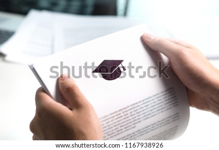 College or university application or letter from school. Student or teacher reading education document. Young man holding grant, graduation, study loan or scholarship paper.