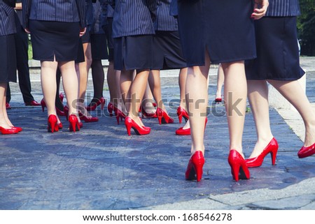 Business woman in red shoes outdoors