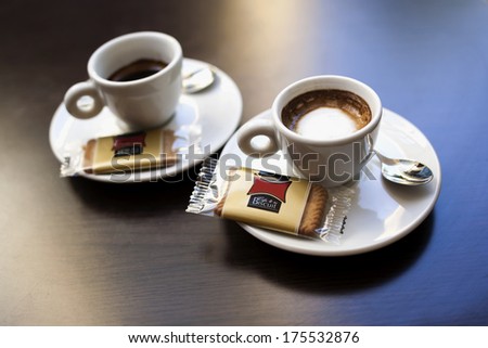 Two cups of coffee with biscuits for two friends