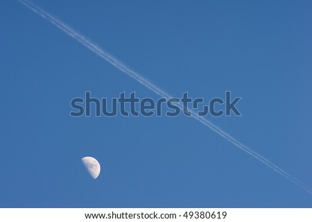 Airplane is flying over the moon in blue sky