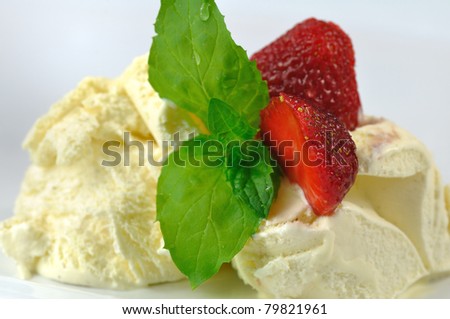 vanilla ice cream with strawberry and mint on a white background