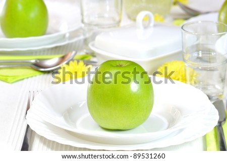 health on a plate, fresh green apples and daisies showing beautiful table composition