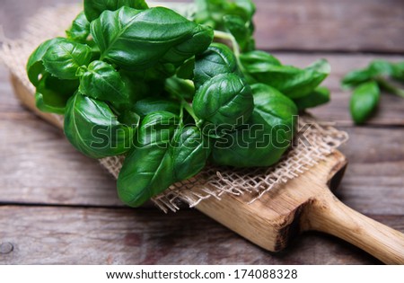 Leaves of basil on a old wooden table