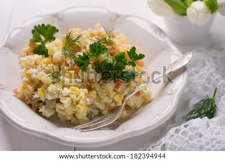 potato salad with boiled vegetables, sweet corn, green peas and herbs