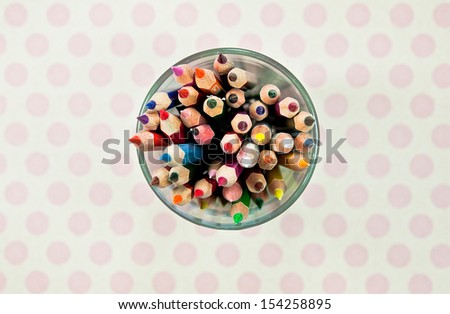 Cup with colorful wooden pencils