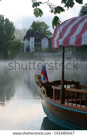 Touristic wooden boat with Slovenian flag on Blad lake, Slovenia