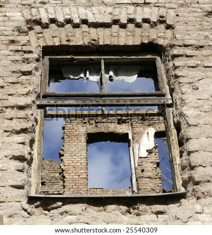 Window on destroyed house as war aftermath