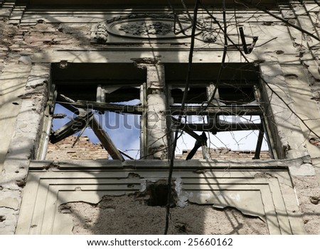 Window on destroyed house as war