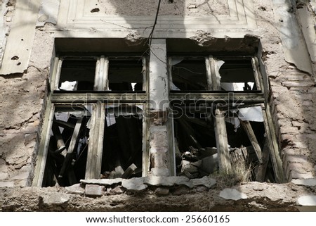 Window on destroyed house as war aftermath