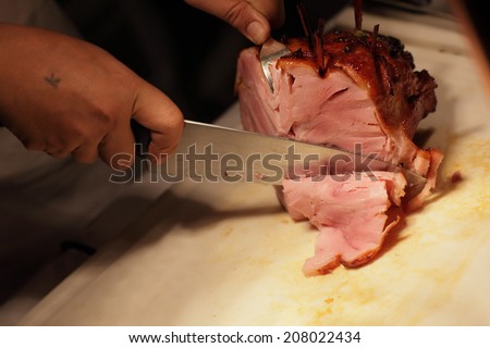 Cook meat sources,Worker cutting the meat