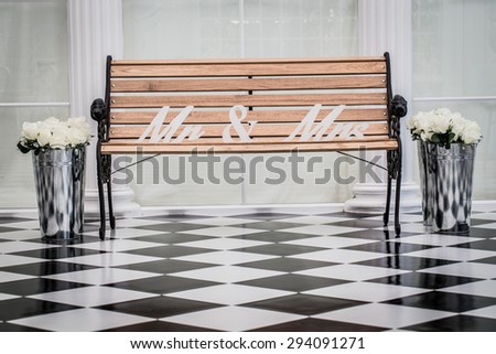Wooden chairs with letters putting Mr. & Mrs. tiled black and white
