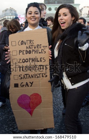PARIS, FRANCE - JANUARY 27 2013 : Women hold a sign in support of gay marriage in Paris, France. Over 300 000 people walked in Paris that day in favor of gay marriage.