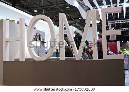 PARIS, FRANCE - JANUARY 24, 2014: People visit a home design stand behind a \