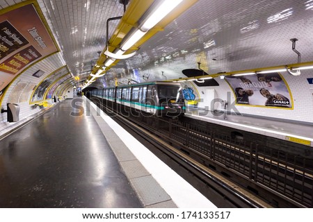 PARIS, FRANCE - CIRCA JANUARY, 2014: A train leaves a platform in the Paris metro. Traffic for the Paris metro is over 2 billion rides per year.