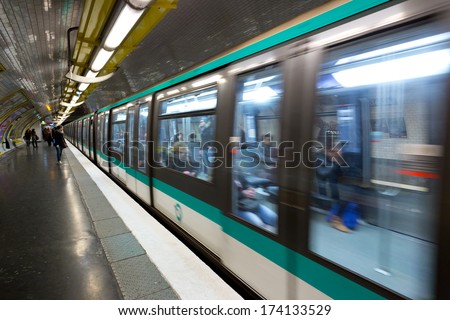 PARIS, FRANCE - CIRCA JANUARY, 2014: A train arrives in a station in the Paris metro. Traffic for the Paris metro is over 2 billion rides per year.