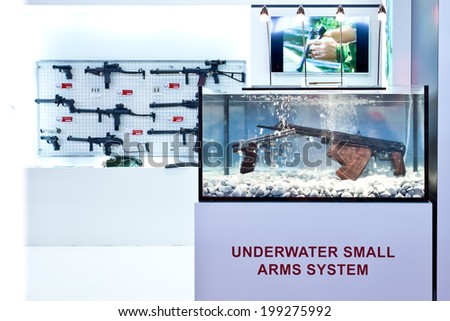 PARIS, FRANCE - JUNE 17, 2014: A stand presents gun in a water tank at Eurosatory, the largest international land and air-land defence and security exhibition in Europe..