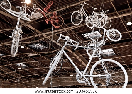 PARIS, FRANCE - JULY 5, 2014: Old bicycles hang from the ceiling at Mode City, a swimwear and lingerie tradeshow where over 20,000 buyers meet 500 exhibitors from 35 different countries.