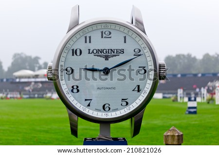 CHANTILLY, FRANCE - JULY 26, 2014: A giant Longines watch gives time in the Longines Global Champions Tour in Chantilly, France.