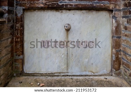 Vault door in a French cemetery. The Latin inscription comes from the beginning of Psalm 130 \
