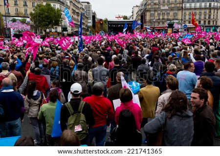 PARIS, FRANCE - OCT. 5, 2014: People wave pink flags during an anti-gay rights protest in Paris. The manifestation drew around 100,000 people that day.