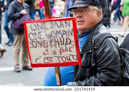 PARIS, FRANCE - OCT. 5, 2014: A man holds a sign during an anti-gay rights protest in Paris, which says \