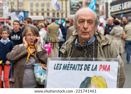 PARIS, FRANCE - OCT. 5, 2014: A man holds a sign that says \