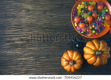 halloween candy party dessert and pumpkin on wood ground