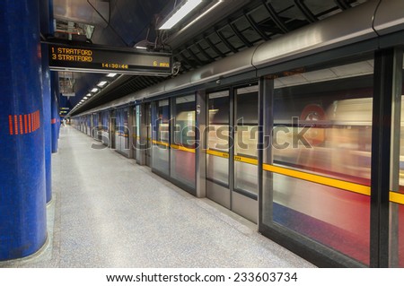 LONDON, UNITED KINGDOM - NOVEMBER 8, 2014: Jubilee line train leaves modern North Greenwich station. The Jubilee line is the newest line on the network.