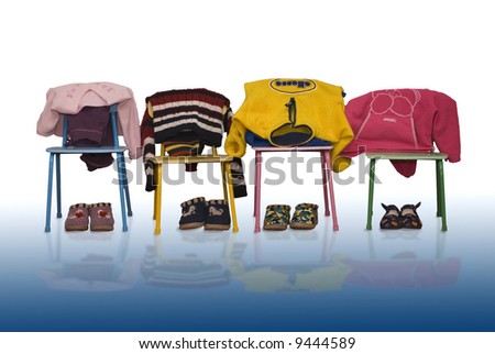 children\'s clothes hanging on chairs  of the kindergarten