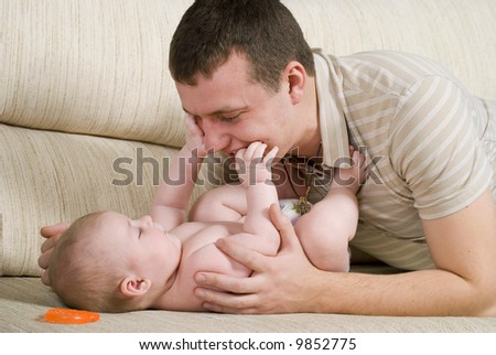 The young man is playing with his little daughter