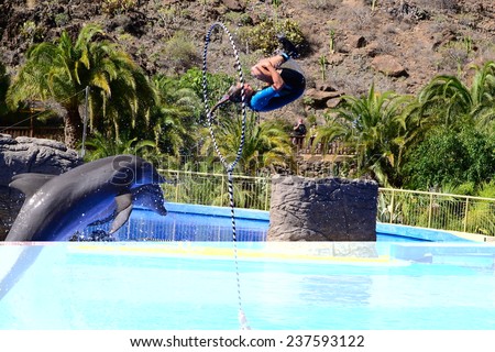 jumping dolphin trainer in Palmitos Park, Spain November 2014