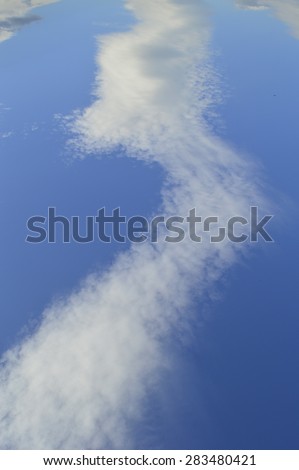 road out of the clouds in the blue sky