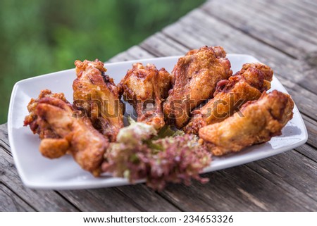 Fried chicken pieces on a plate.