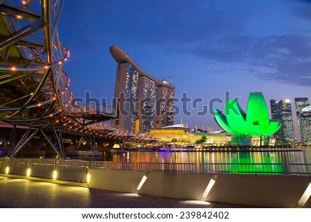 SINGAPORE - Oct 27, 2014: The Helix Bridge, Marina bay sands & Artscience museum at night. Marina Bay Sand iconic design has transformed Singapore\'s skyline. Designed by architect Moshe Safdie.