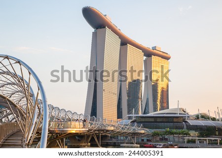 SINGAPORE - Oct 27, 2014: The Helix Bridge, Marina bay sands & Artscience museum at night. Marina Bay Sand iconic design has transformed Singapore\'s skyline. Designed by architect Moshe Safdie.