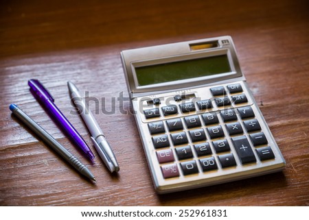 calculator and pen on a business background