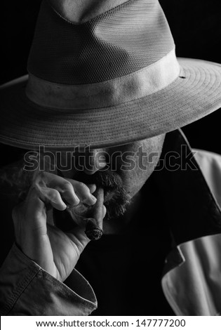 Man Smoking Cigar Wears Hat