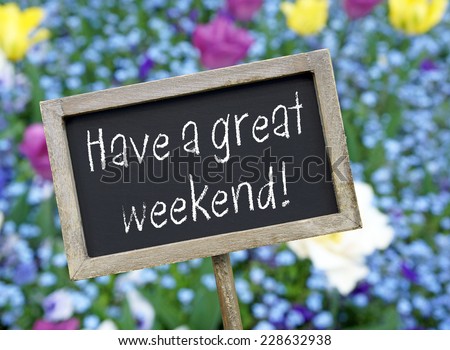Have a great weekend - Chalkboard with flowers in the background
