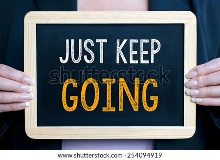 Just keep going - Businesswoman with blackboard