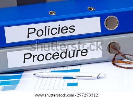 Policies and Procedure - two binders on desk in the office