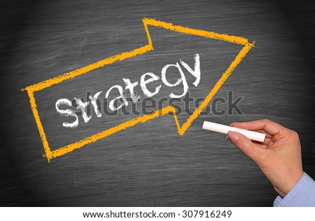 Strategy - female hand with chalk and arrow with text