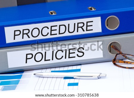 Procedure and Policies - two binders on desk in the office
