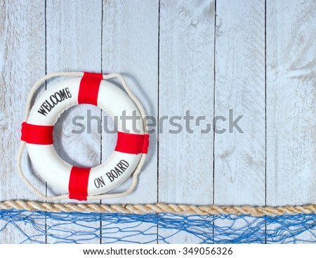 Welcome on Board - Lifebuoy with text on wooden background with copyspace for individual text