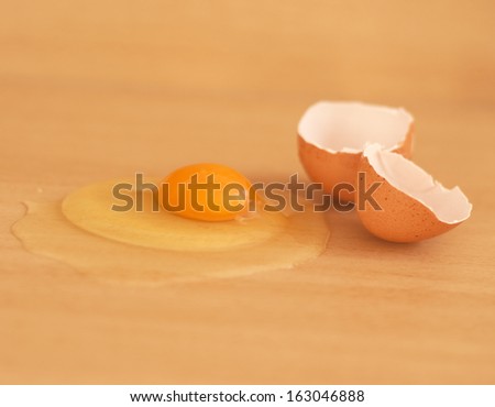 Broken egg on wooden table