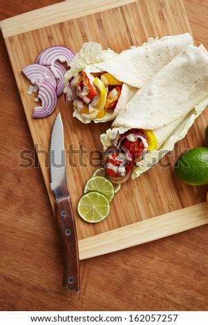 tandoori masala spiced tortilla wraps with lettuce, peppers, lime and onion