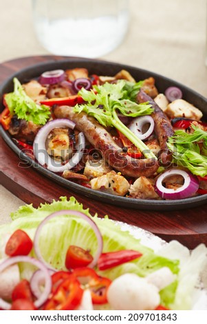 baked diced chicken and sausage with onions, peppers, mushrooms and a salad of tomatoes, mushrooms, peppers and lettuce.