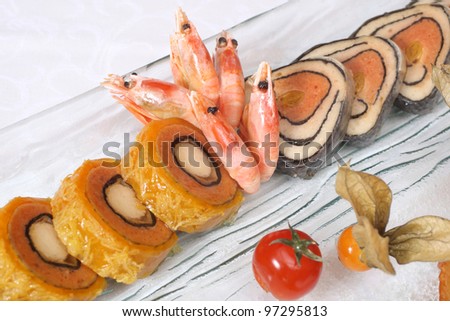 Stuffed fish and prawns with vegetables on plate